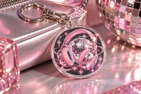Photo keyrings with original kpop-inspired artwork: pink chrome headphones and disco sphere